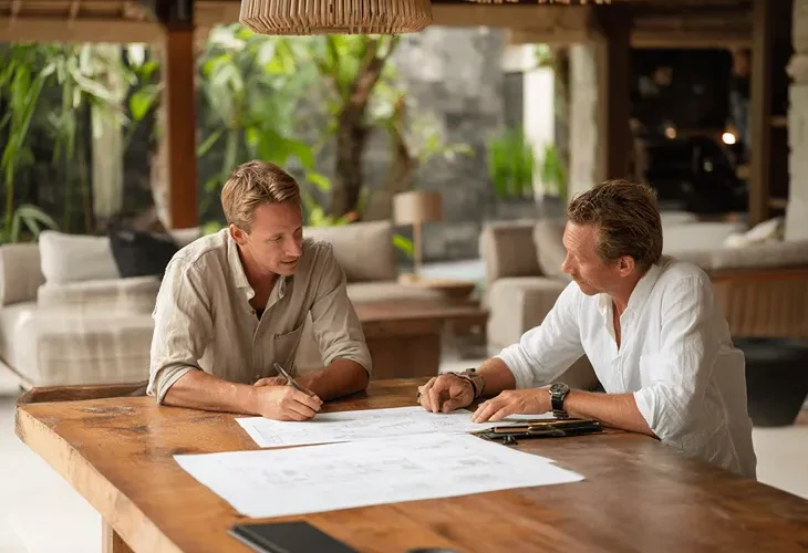 Emergency repairs for villas in Bali 2026 - Maintenance team fixing a leaking Alang-Alang roof for a property.