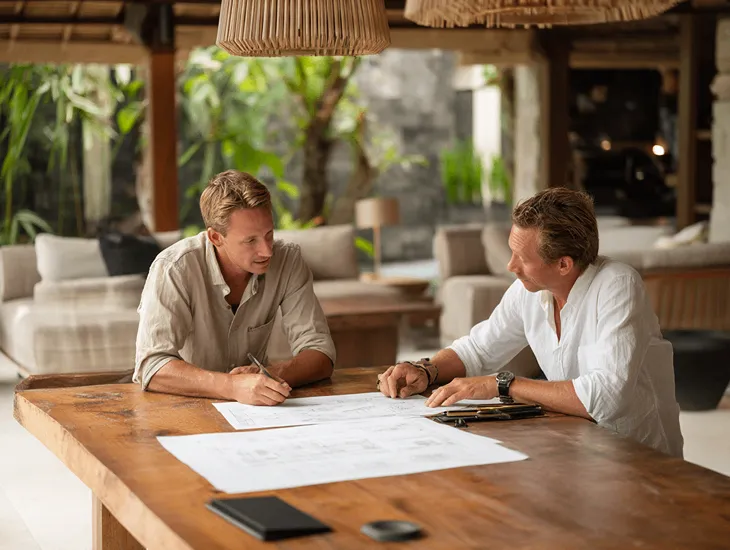 Emergency repairs for villas in Bali 2026 - Maintenance team fixing a leaking Alang-Alang roof for a property.